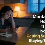 Mental Health Recovery: exhausted woman at a kitchen table looking down at her phone, with a glass of water and a notebook nearby.
